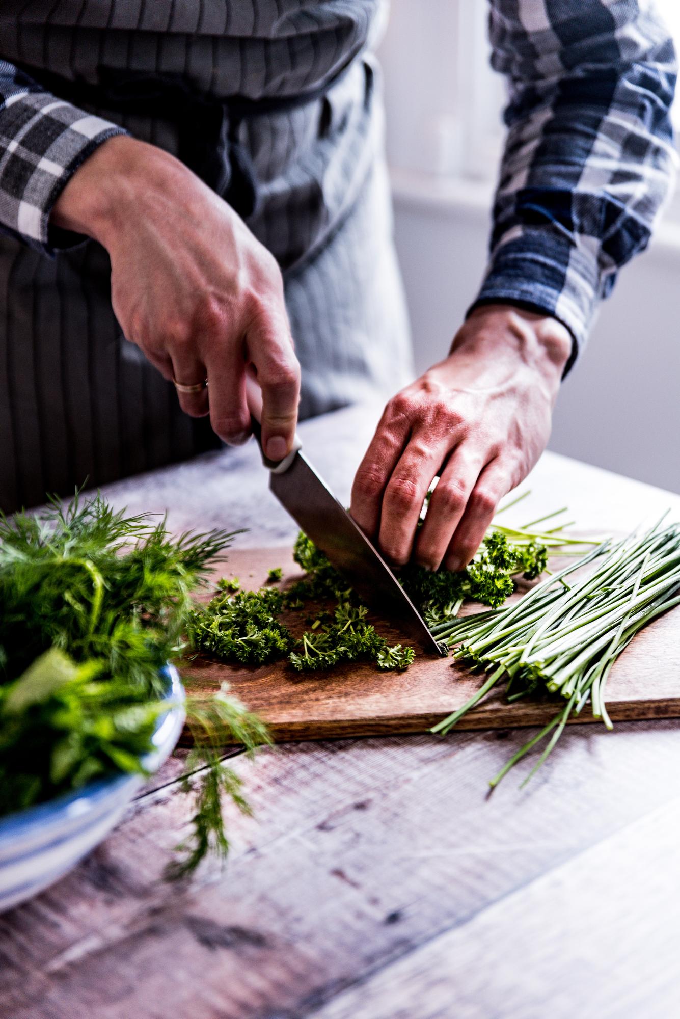 Close-up of hands preparing fresh herbs